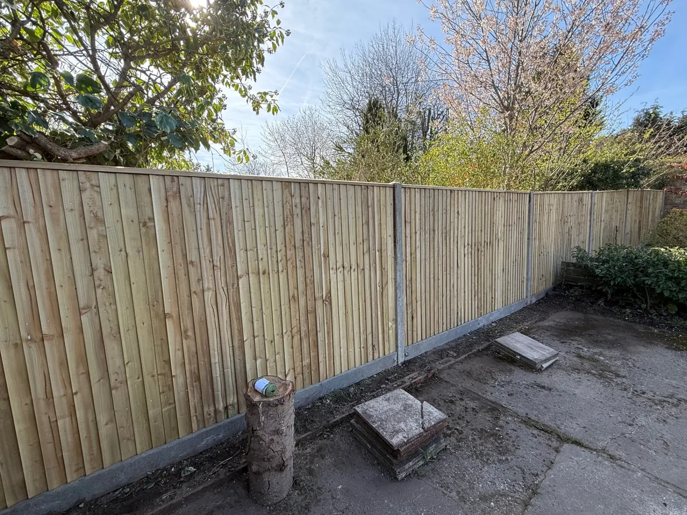 Feather edge closeboard fence with concrete posts and gravel boards