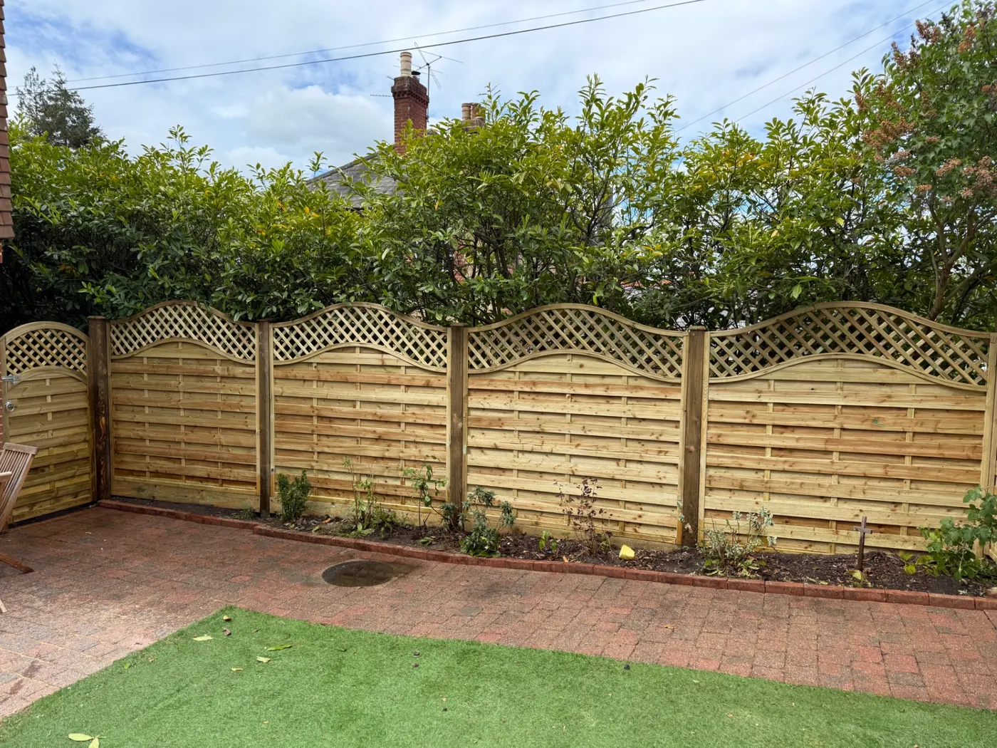 Omega trellis topped garden fence panels installed