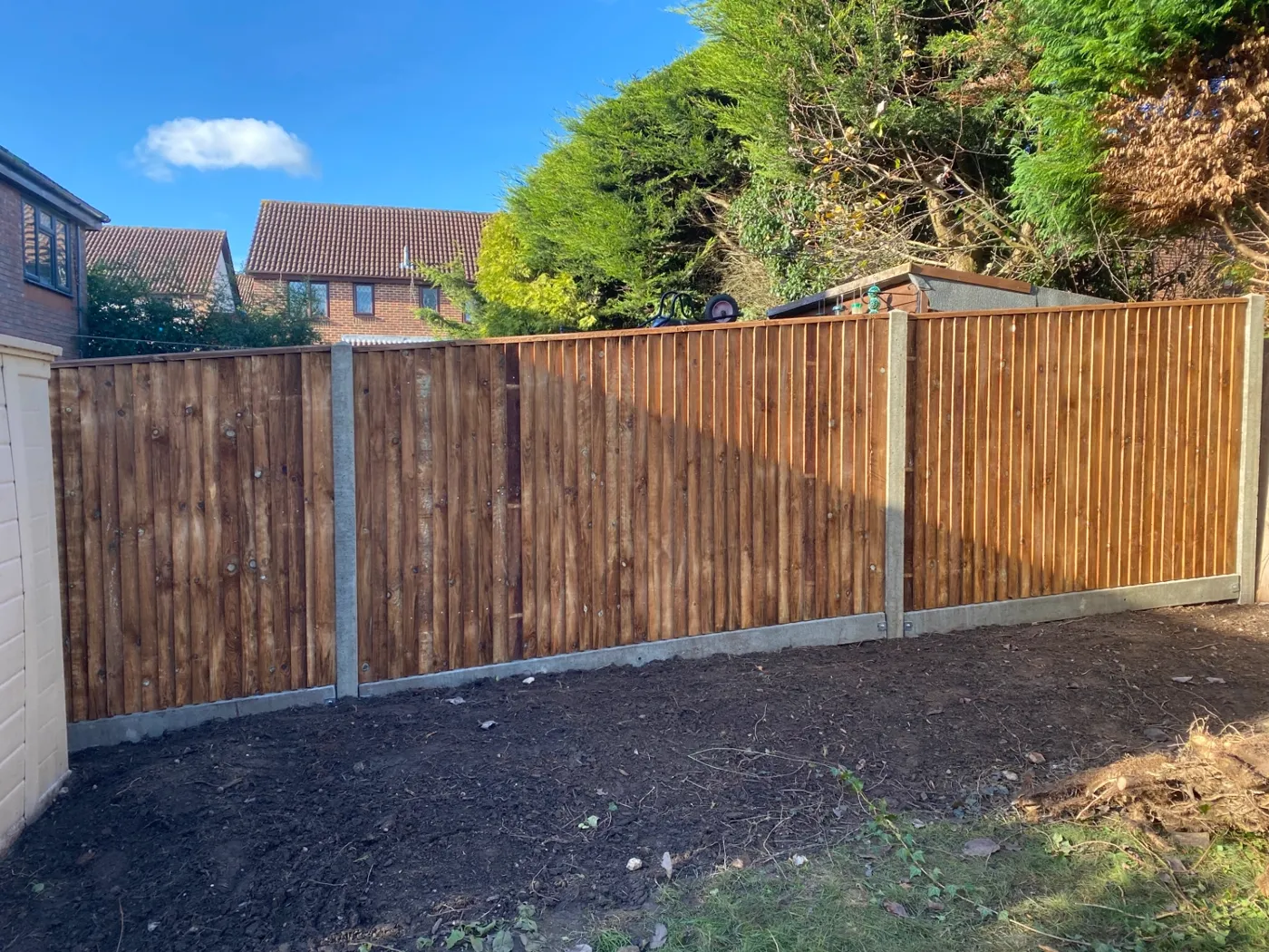 New feather edge closeboard fence with concrete posts and gravel boards